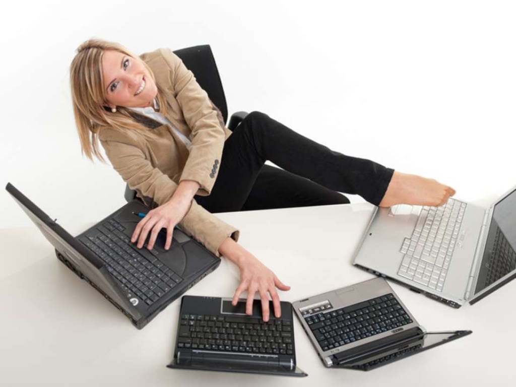 Woman so swamped with work she's trying to use four laptops at once